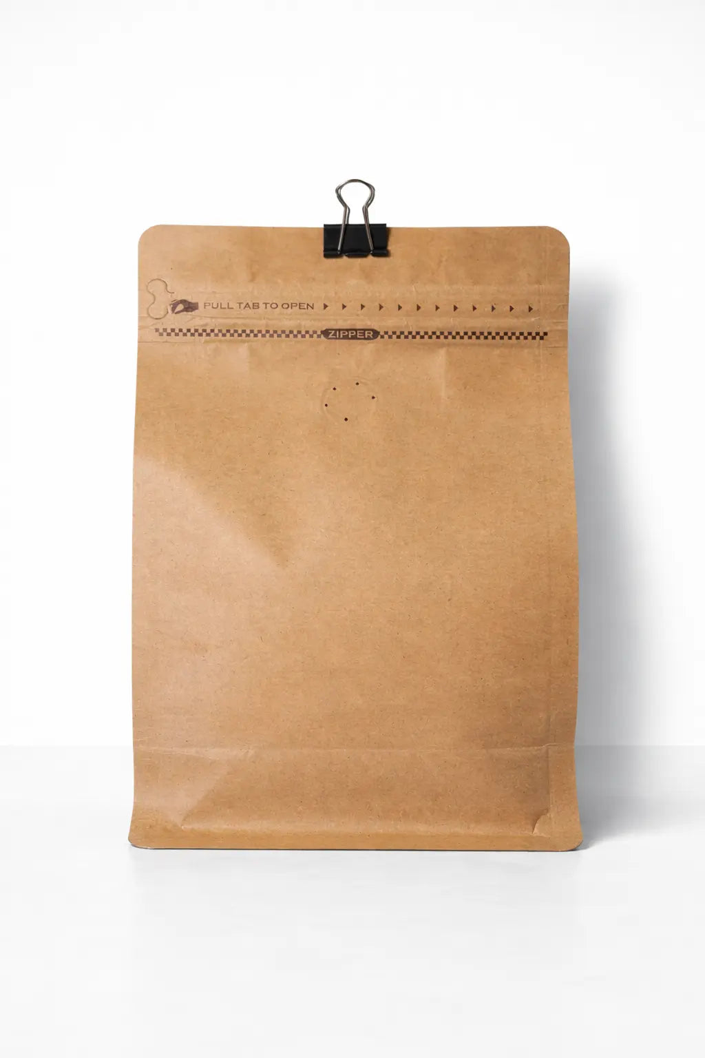 Brown paper bag with a clip on a white background